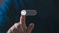 Close-up of a finger activating a futuristic toggle switch icon on a dark gradient background Royalty Free Stock Photo