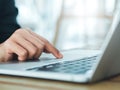 Close-up finger of business person in suit touch on touchpad on laptop computer. Working on notebook, business technology concept. Royalty Free Stock Photo