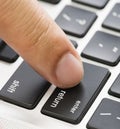 Close up finger on enter button of keyboard Royalty Free Stock Photo