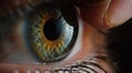 Close-up of finger placing a contact lens gently on the iris of the eye in detail Royalty Free Stock Photo
