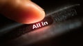 Finger Hovers Over All In Button on Screen, Moment of Decision Captured With Dramatic Lighting and Focus Royalty Free Stock Photo