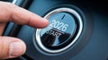Finger pressing a car button that displays the year 2026 and the word start. Royalty Free Stock Photo