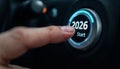Finger pressing a car button that displays the year 2026 and the word start. Royalty Free Stock Photo