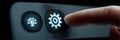 Close-up of a Finger Pressing a Gear Icon on a Digital Interface at a Technology Setting During the Evening Royalty Free Stock Photo