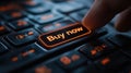Close up of finger pressing glowing buy now button on keyboard