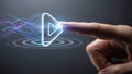 Finger Touching Glowing Play Button with Abstract Light Trails on Dark Background Royalty Free Stock Photo