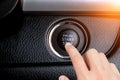 Close up of finger pressing the start/stop engine button. Royalty Free Stock Photo