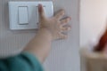 Close up fingerÃ¢â¬â¢s kid is turning on or turning off the light-switch. Education about the economical use of resources Royalty Free Stock Photo