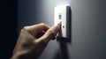Close up of finger turn off on light switch at the wall. Energy saving concept. Selected focus Royalty Free Stock Photo