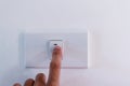 Close up of finger is turning on or off on light switch. Royalty Free Stock Photo