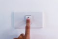 Close up of finger is turning on or off on light switch. Royalty Free Stock Photo