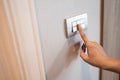 Close up of finger is turning on or off in light switch Royalty Free Stock Photo