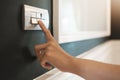 Close up of finger is turning off on light switch over green wall at the hotel Royalty Free Stock Photo