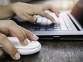 White wireless mouse on wooden desk Royalty Free Stock Photo