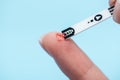 Close up of fingers and diabetes test strip isolated Royalty Free Stock Photo