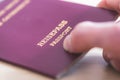 Passport vacation concept: Close up of fingers holding a passport, arrival or departure, Ã¢â¬ÅReisepass Passport