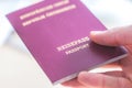 Passport vacation concept: Close up of fingers holding a passport, arrival or departure, Ã¢â¬ÅReisepass Passport