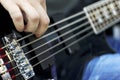 Close up on the fingers of musician playing bass guitar on the stage Royalty Free Stock Photo