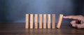 Close-up fingers prevent the wooden block jenga game stick from falling domino Royalty Free Stock Photo