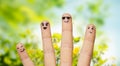 Close up of fingers with smiley faces over nature Royalty Free Stock Photo