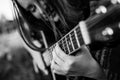 Close-up fingers on the strings, girl playing acoustic guitar. Black and white photo. Royalty Free Stock Photo