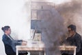 Close-up of fire burning inside the office cabin during works. Men and women office workers in a fire. Short circuit and Royalty Free Stock Photo