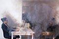 Close-up of fire burning inside the office cabin during works. Men and women office workers in a fire. Short circuit and Royalty Free Stock Photo