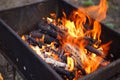 Close up of fire on chargrill. Dry sticks smoulder. Concept of cooking on grill Royalty Free Stock Photo