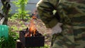 Close up of fire on chargrill. Dry sticks smoulder. Concept of cooking on grill.