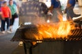 Close Up of Fire Cooking Sausages in the Street during Italian Celebration