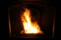 Close-up of fire in lit wood pellet stove