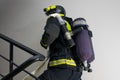 Close-up, a firefighter, having laid a line for water supply, is waiting for a command to extinguish from a trunk, being in the