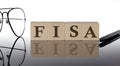 Close-up Of FISA Wooden Blocks on the black background with glasses and pen Royalty Free Stock Photo