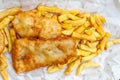 Close up fish and chips in cardboard takeaway, traditional English meal. Royalty Free Stock Photo