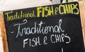 Close up on a fish and chips sign, Traditional fish and chips written on a blackboard in the street