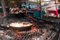 Close-up of fish croquettes frying in a pan over an artisan stove in a poor restaurant on the beach in Masachapa