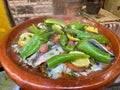 Close up of Fish Tajine, Moroccan slow-cooked stew served and cooked in earthenware pot in Medina of Marrakech, Morocco.