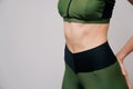 Close up of fit female abs  on a light background with copy space. Fitness female and trained belly, Perfect Slim Body. Royalty Free Stock Photo