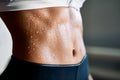 Close up of fit woman torso with sweat on skin after workout Royalty Free Stock Photo