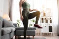 Close up fitness women is stretching leg before exercise at home