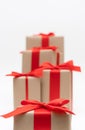 Close-up brown paper gift box red bow ribbon white background. concept for happy love gift Royalty Free Stock Photo