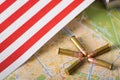 Close up of five bullets with a United States flag on a map, on wooden table