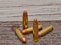 Four handgun bullets with a wooden background