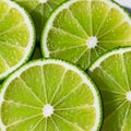 Close-up of five lime slices showing vibrant green color and textured pulp. The segments are Royalty Free Stock Photo