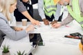 Close up of five multiracial people working with drawings