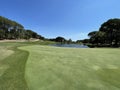 Golf green on a lake with blue sky Royalty Free Stock Photo