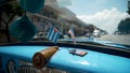 Close-up of flags of America and Cuba in car. Action. Beautiful flags adorn panel of retro car on background of road in