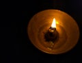Close up of the flame of diyas in black dark background at night. Selective focus on flame.
