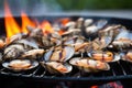 close-up of flames licking clam shells on a grill Royalty Free Stock Photo