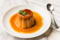 Close up of a flan creme caramel pudding with mint, a custard dessert. Royalty Free Stock Photo